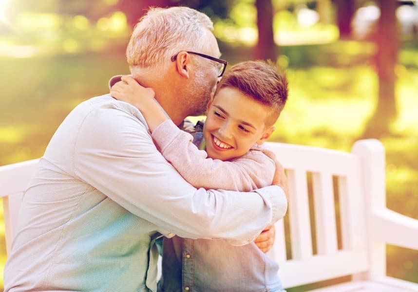 Grandfather and grandson hugging